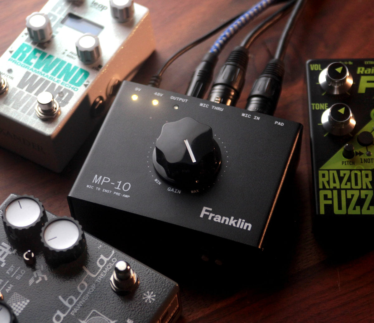 Preamplificador Franklin MP-10 negro sobre madera, entre pedales de efectos y cables XLR